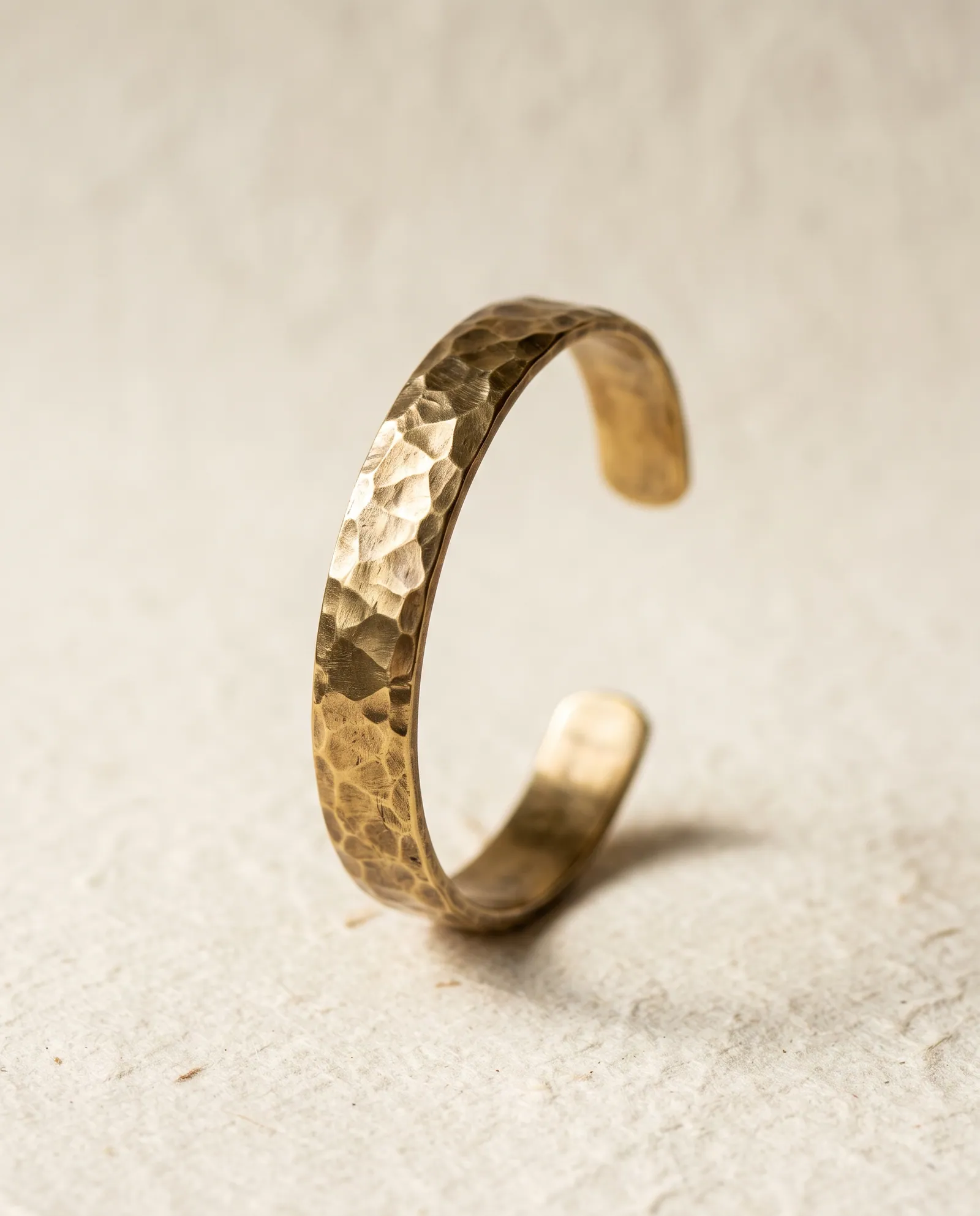 Hand-hammered brass open cuff bracelet standing upright